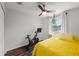 Bedroom featuring a ceiling fan, hardwood floors, and a cozy workout space at 10255 Hartford Maroon Rd, Orlando, FL 32827
