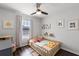 Cozy bedroom with hardwood floors, a large window, and playful decor at 10255 Hartford Maroon Rd, Orlando, FL 32827