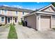 Townhome exterior showing garage, front door, and landscaping with curb appeal at 10255 Hartford Maroon Rd, Orlando, FL 32827