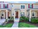 Charming townhouse with a well-maintained lawn and a welcoming red front door with a lovely green wreath at 10255 Hartford Maroon Rd, Orlando, FL 32827