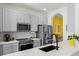 Well-lit kitchen with stainless steel appliances, gray cabinets, and ample counter space at 10255 Hartford Maroon Rd, Orlando, FL 32827
