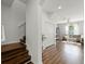 Inviting living room featuring wood floors, a staircase, and a glimpse of a cozy seating area at 10255 Hartford Maroon Rd, Orlando, FL 32827
