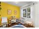 Cheerful playroom with yellow walls, a blue and white rug, and -friendly furniture at 10255 Hartford Maroon Rd, Orlando, FL 32827