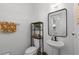 Modern powder room featuring a pedestal sink, sleek mirror, and stylish decor at 10255 Hartford Maroon Rd, Orlando, FL 32827
