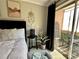 Comfortable bedroom featuring a pet bed, black accent table, and sliding door to a private balcony at 109 Oyster Bay Cir # 120, Altamonte Springs, FL 32701