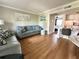 Open-concept living space showcases hardwood floors, neutral walls, stylish furniture, and a seamless flow into the kitchen at 109 Oyster Bay Cir # 120, Altamonte Springs, FL 32701