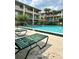 Inviting community pool surrounded by lush landscaping, lounge chairs, and multi-story buildings in the background at 109 Oyster Bay Cir # 120, Altamonte Springs, FL 32701