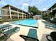 Community pool area with comfortable lounge chairs and well-maintained landscaping at 109 Oyster Bay Cir # 120, Altamonte Springs, FL 32701