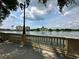 Picturesque waterfront view features a scenic pier, calm water, and distant buildings under a beautiful sky at 109 Oyster Bay Cir # 120, Altamonte Springs, FL 32701