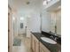 Bathroom with a large granite countertop vanity, tile floor, and access to the toilet and shower at 11091 Bagley Aly, Windermere, FL 34786