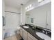 Well-lit bathroom features double sinks, granite countertop, and combined tub and shower at 11091 Bagley Aly, Windermere, FL 34786