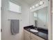 Bathroom features a black granite countertop, towel rack, and a large mirror at 11091 Bagley Aly, Windermere, FL 34786