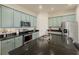 Bright kitchen featuring light blue cabinets, stainless steel appliances, and a black countertop at 11091 Bagley Aly, Windermere, FL 34786