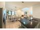 Open-concept kitchen featuring a large island with black granite countertops and stainless steel appliances at 11091 Bagley Aly, Windermere, FL 34786