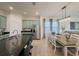 Beautiful kitchen showcasing granite countertops, stainless steel appliances, and an adjacent dining area with ample natural light at 11091 Bagley Aly, Windermere, FL 34786
