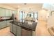 Open-concept kitchen featuring a large island with black granite countertops and stainless steel appliances at 11091 Bagley Aly, Windermere, FL 34786