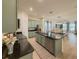 Open kitchen with stainless appliances, dark granite counters, and an island, seamlessly connected to the living areas at 11091 Bagley Aly, Windermere, FL 34786