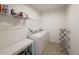 Functional laundry room with washer, dryer, storage shelf, and tiled floors at 11091 Bagley Aly, Windermere, FL 34786