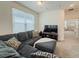 Cozy upstairs living room features a comfortable gray sectional sofa and a TV at 11091 Bagley Aly, Windermere, FL 34786