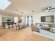 Bright, open living space features an inviting sofa, dining area, and a kitchen with sleek countertops at 11091 Bagley Aly, Windermere, FL 34786