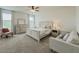 Bright main bedroom with a king-size bed, dresser, and sitting area with natural light at 11091 Bagley Aly, Windermere, FL 34786