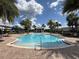 Community pool surrounded by lush landscaping and palm trees at 11091 Bagley Aly, Windermere, FL 34786