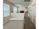Hallway features carpeted floors and leads to bedrooms and living area with a TV at 11091 Bagley Aly, Windermere, FL 34786