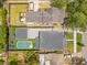 An overhead aerial shows the home with its detached garage, inground pool, and adjacent neighbors at 1127 W Harvard St, Orlando, FL 32804