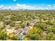 A beautiful aerial view shows the home, neighborhood, mature trees, and the city skyline in the distance at 1127 W Harvard St, Orlando, FL 32804