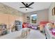 Bright ' bedroom with toys and a play area, accented by colorful floral wallpaper and decor at 1127 W Harvard St, Orlando, FL 32804
