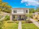 Beautiful home featuring an inviting front porch, stone chimney accent, and lovely landscaping with a brick pathway at 1127 W Harvard St, Orlando, FL 32804