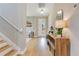 Bright foyer features wood floors, console table and a view into the living room at 1127 W Harvard St, Orlando, FL 32804