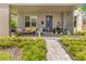 Inviting front porch with comfortable seating, stylish decor, and lush landscaping leading to a modern home at 1127 W Harvard St, Orlando, FL 32804
