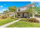 Beautifully landscaped front yard leading to a home with a stone chimney accent and an inviting covered porch at 1127 W Harvard St, Orlando, FL 32804