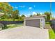 A detached two-car garage complements a backyard pool area with lounge chairs, landscaping, and a paved drive at 1127 W Harvard St, Orlando, FL 32804