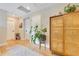 Hallway with hardwood flooring, area rug, and decorative cabinet at 1127 W Harvard St, Orlando, FL 32804