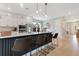 Modern kitchen with white cabinetry, black hardware, and a large center island at 1127 W Harvard St, Orlando, FL 32804