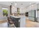 Modern kitchen with large island, white cabinets, stainless steel appliances and backyard views at 1127 W Harvard St, Orlando, FL 32804