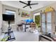 Bright home office featuring dual monitors, a stationary bike, and natural light with leafy trees visible at 1127 W Harvard St, Orlando, FL 32804