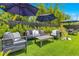 An outdoor living area features a sofa, club chairs, coffee table, and umbrellas at 1127 W Harvard St, Orlando, FL 32804