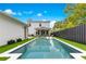 The backyard features a swimming pool with white trim, lounge chairs, and outdoor dining and living at 1127 W Harvard St, Orlando, FL 32804