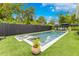 A stunning backyard featuring a modern pool, lush landscaping, and stylish outdoor seating with dual umbrellas at 1127 W Harvard St, Orlando, FL 32804