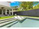 Backyard swimming pool with integrated lounge chairs and lush landscaping offers a serene oasis at 1127 W Harvard St, Orlando, FL 32804
