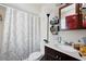Bright bathroom with a decorative shower curtain and wood vanity at 114 Floral Dr, Kissimmee, FL 34743