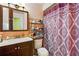 Functional bathroom with a vanity, toilet, and a shower with a decorative curtain at 114 Floral Dr, Kissimmee, FL 34743