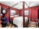 Luxurious primary bedroom with a large, ornate four-poster bed and decor at 114 Floral Dr, Kissimmee, FL 34743
