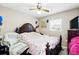 Bedroom with a large wooden bed and neutral decor at 114 Floral Dr, Kissimmee, FL 34743