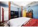 Bedroom area with a large bed, TV, and access to an en-suite bathroom at 114 Floral Dr, Kissimmee, FL 34743