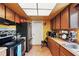 Functional kitchen featuring wood cabinetry and black appliances at 114 Floral Dr, Kissimmee, FL 34743