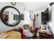 Cluttered living room with modern TV and large round mirror at 114 Floral Dr, Kissimmee, FL 34743